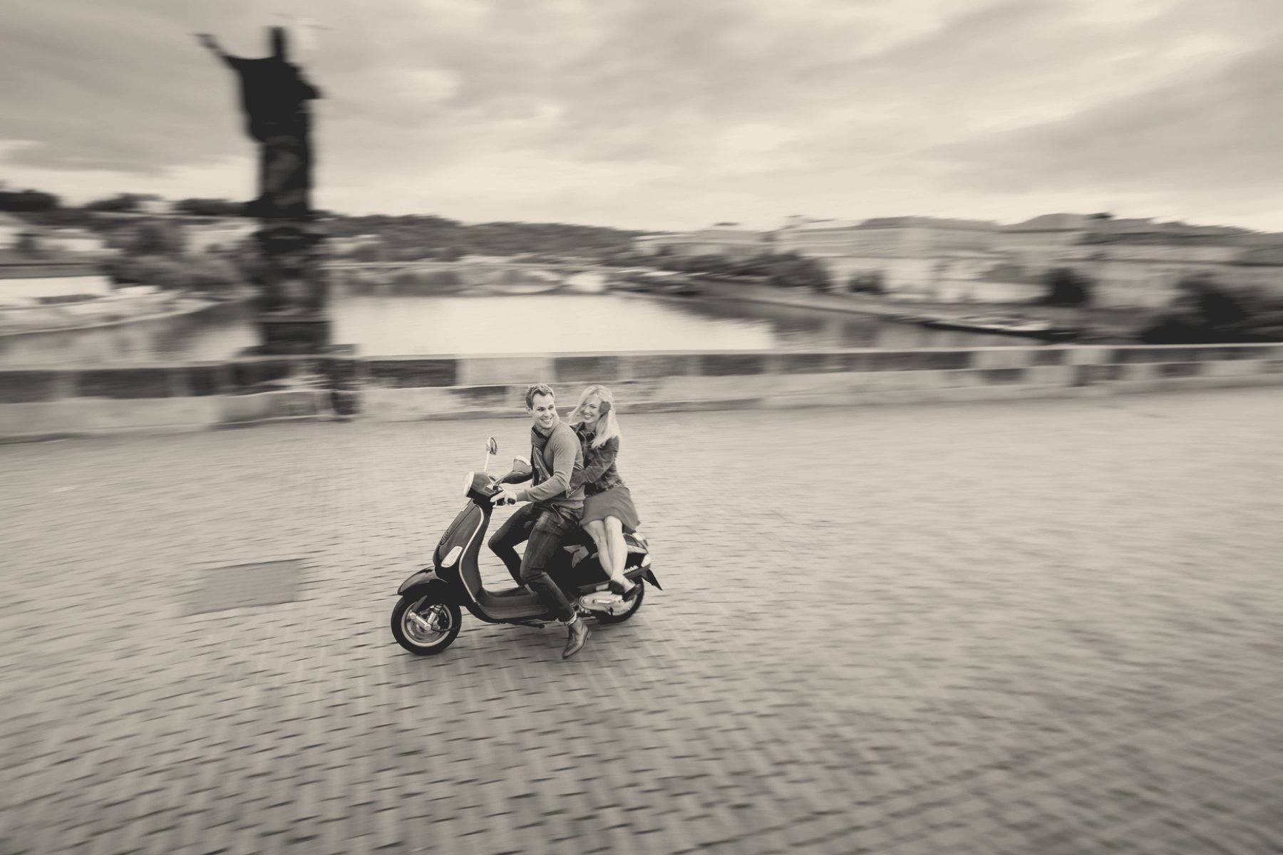 Monika and Jaroslav crossing Charles Bridge on a scooter